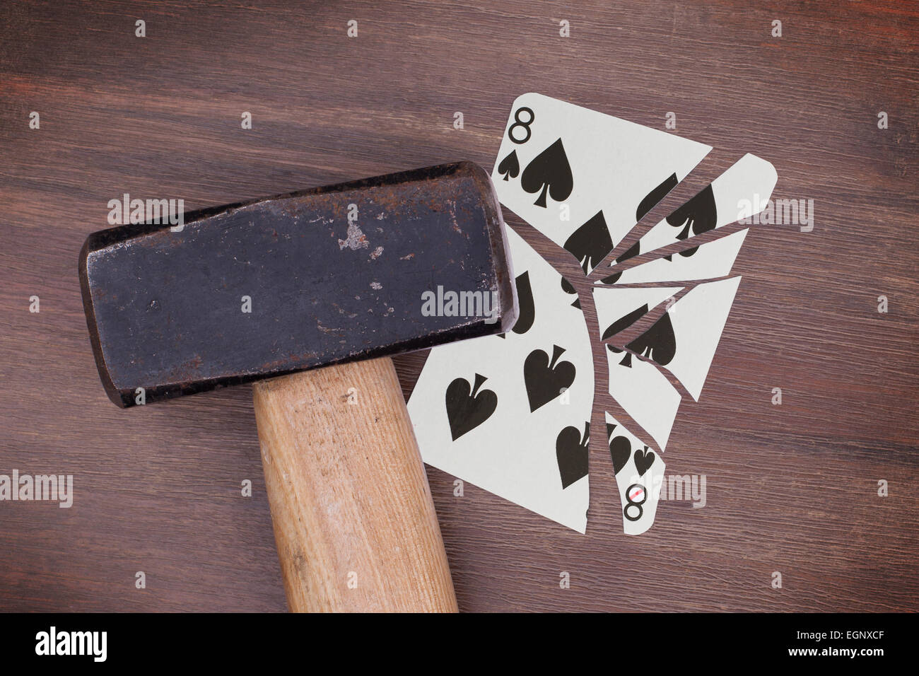 Hammer with a broken card, vintage look, eight of spades Stock Photo