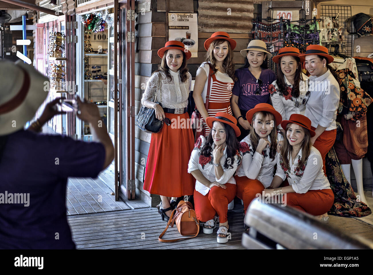 Matching clothes. Group of women in matching red outfits pose for a photograph. Thailand Southeast Asia Stock Photo