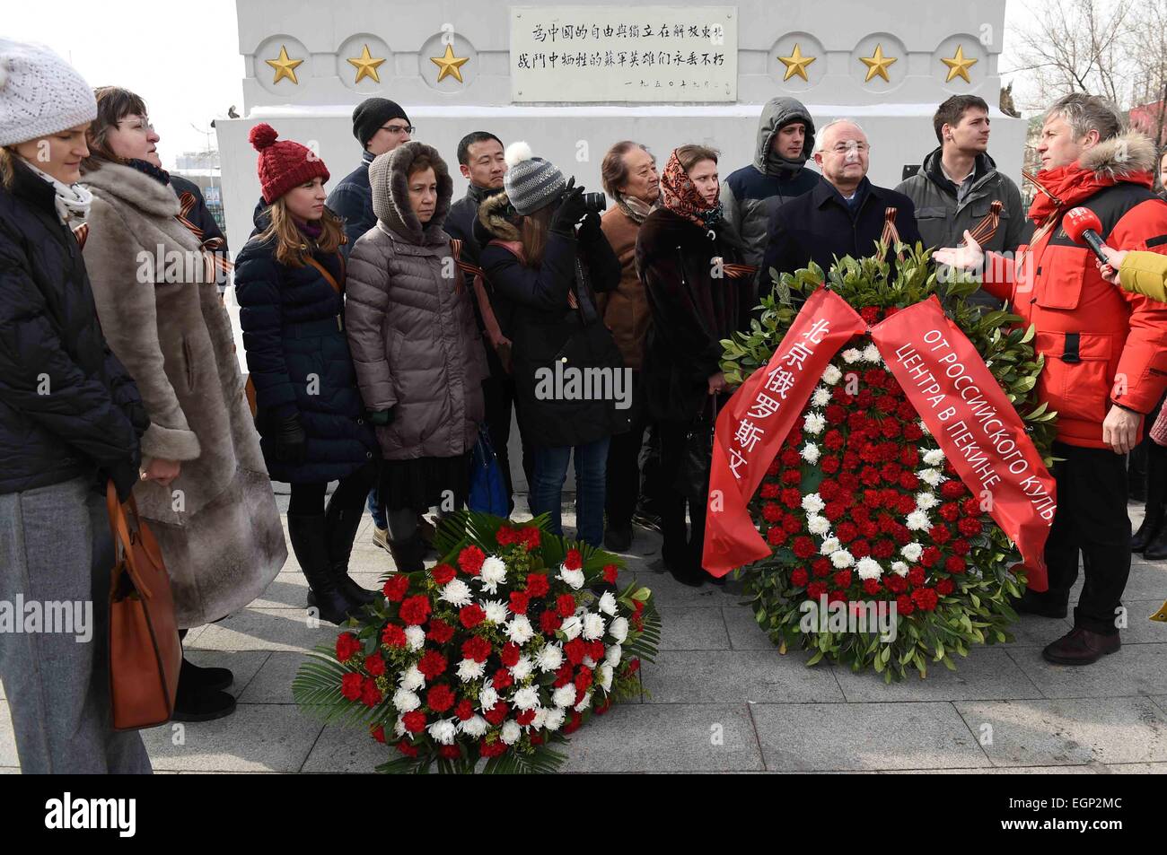 Harbin,China. 28th Feb, 2015. Representatives of Russians living in Harbin, capital of northeast China's Heilongjiang Province, pose for a group picture after laying flowers at Soviet martyrs monument in Harbin, Feb. 28, 2015. Dozens of Russians living and working in Harbin attended a commemorative activity for Soviet Red Army soldiers who sacrificed during World War II on Saturday. The monument was set up in 1945 to commemorate Soviet soldiers who were killed in the fight against the Japanese invaders in China. Credit:  Wang Jianwei/Xinhua/Alamy Live News Stock Photo