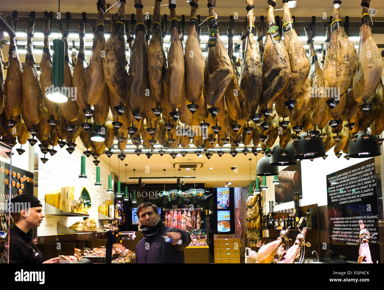 Serrano Iberian Ham legs, Jamon iberico, hanging from cealing,  Viandas de Salamanca, Madrid, Spain. Stock Photo