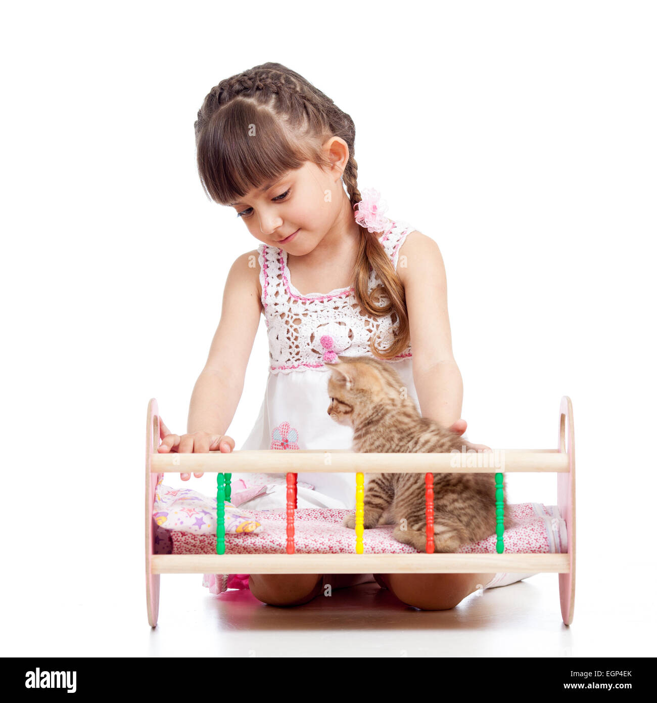kid playing with a kitten and rocking him in doll crib Stock Photo - Alamy