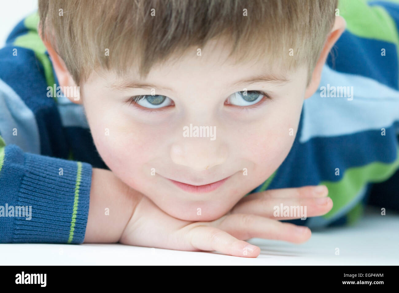 5 year old boy laying down and looking up Stock Photo