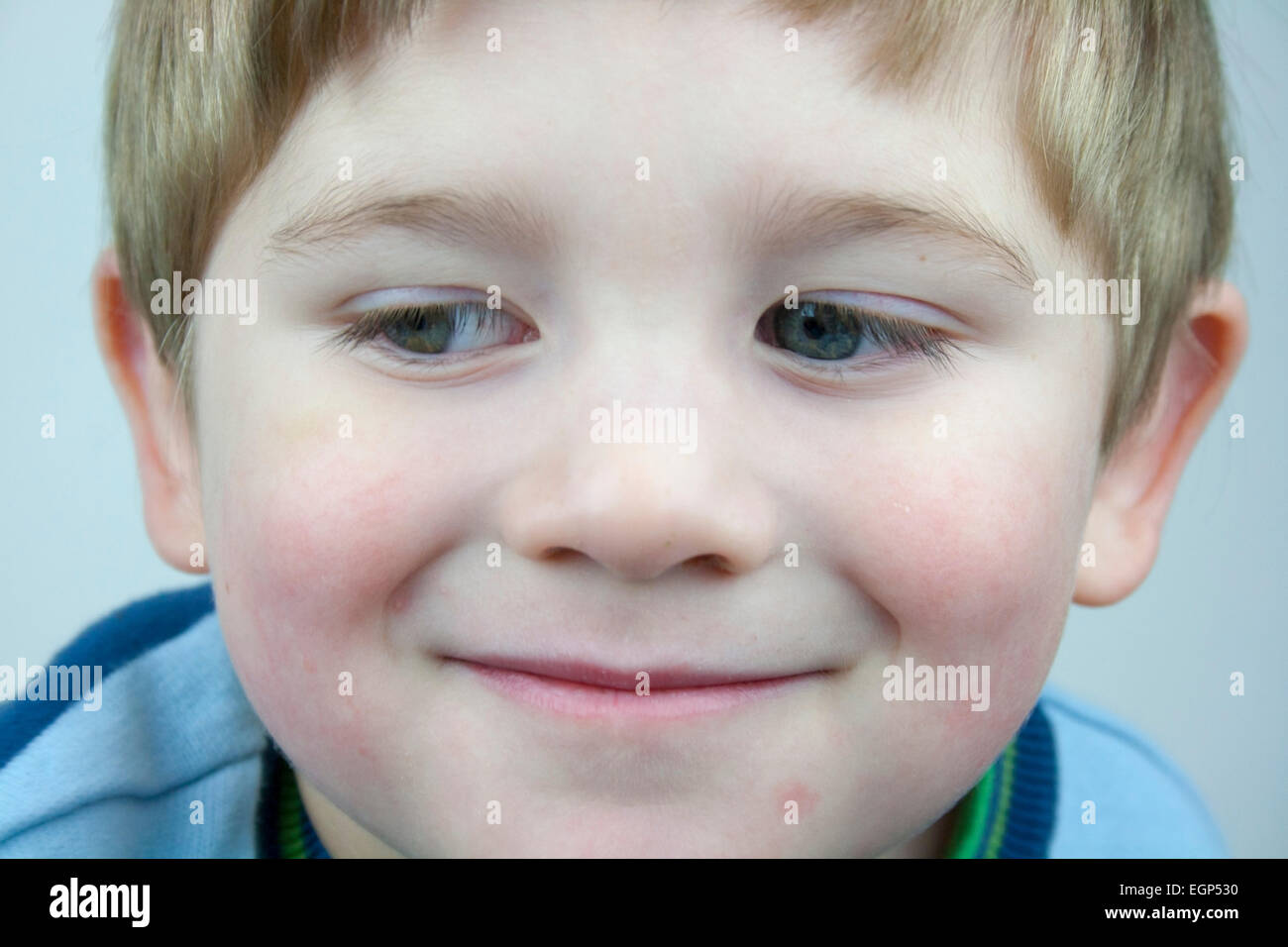 5 year old boy face shots close up looking down right expression Stock