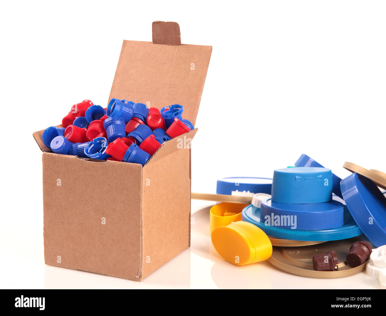 a paperboard box with a lot of caps for recycle on a white background