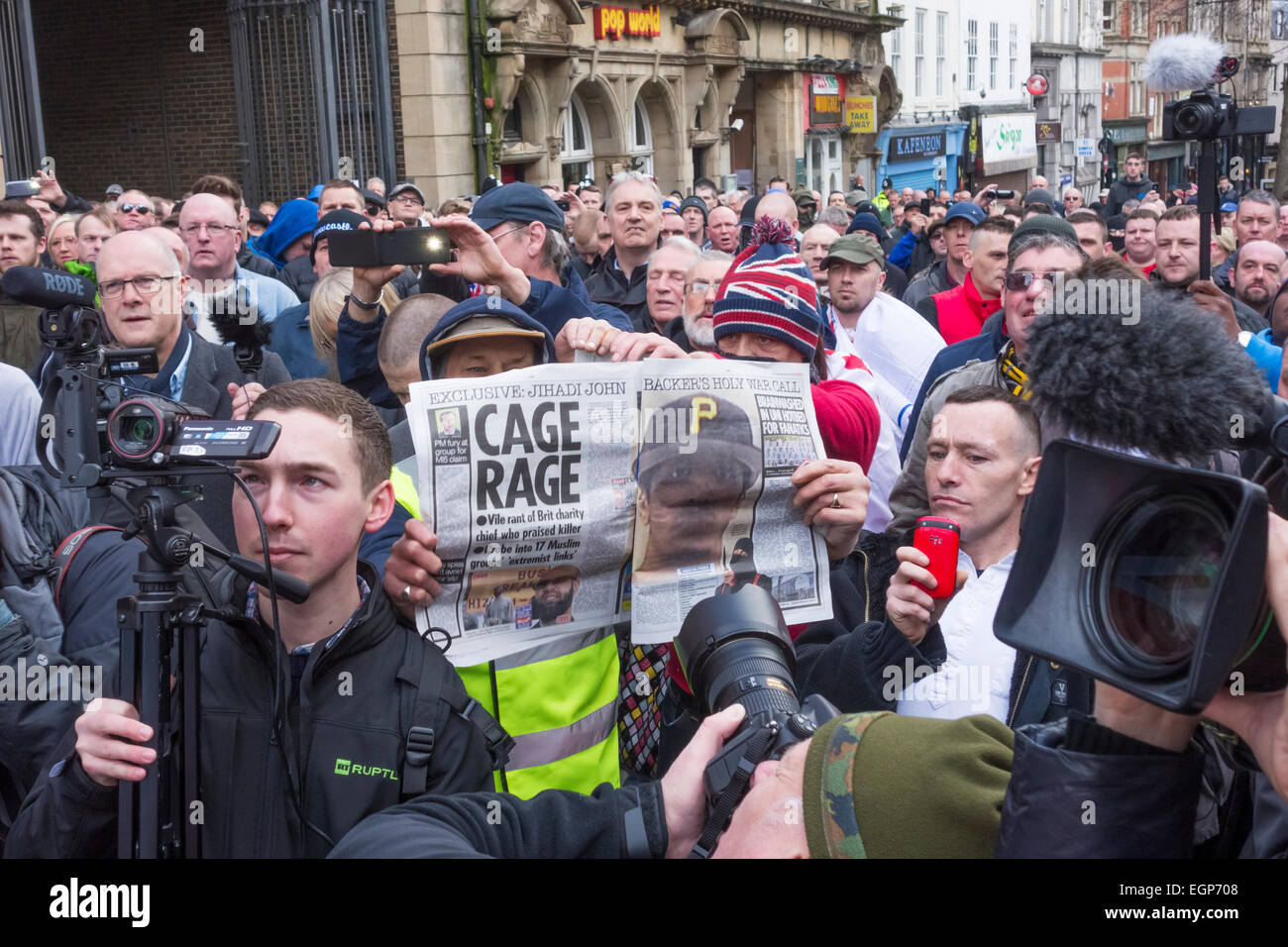 Newcastle upon Tyne, UK. 28th February, 2015. Protester holds up copy of The Sun while listening to speaker at first UK protest by Pegida UK, a group opposed to the 'Islamisation of Europe'. The protest was held in The Bigg Market area of Newcastle city centre, while a counter protest organised by Newcastle Unites was held less than a hundred metres away in Newgate Street Credit:  ALANDAWSONPHOTOGRAPHY/Alamy Live News Stock Photo