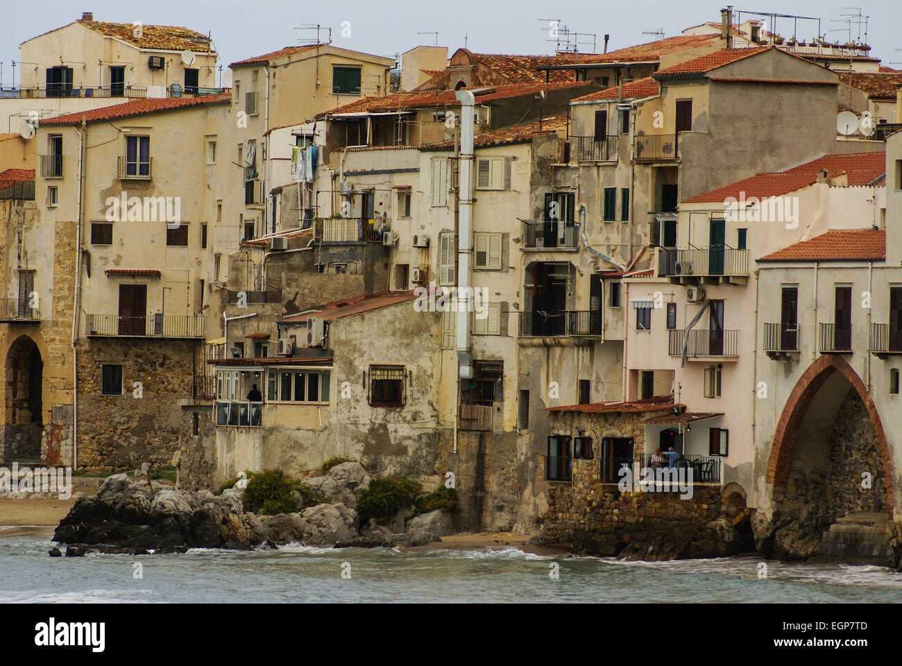 Houses along the shoreline and cathedral in background, Cefalu, Sicily Stock Photo