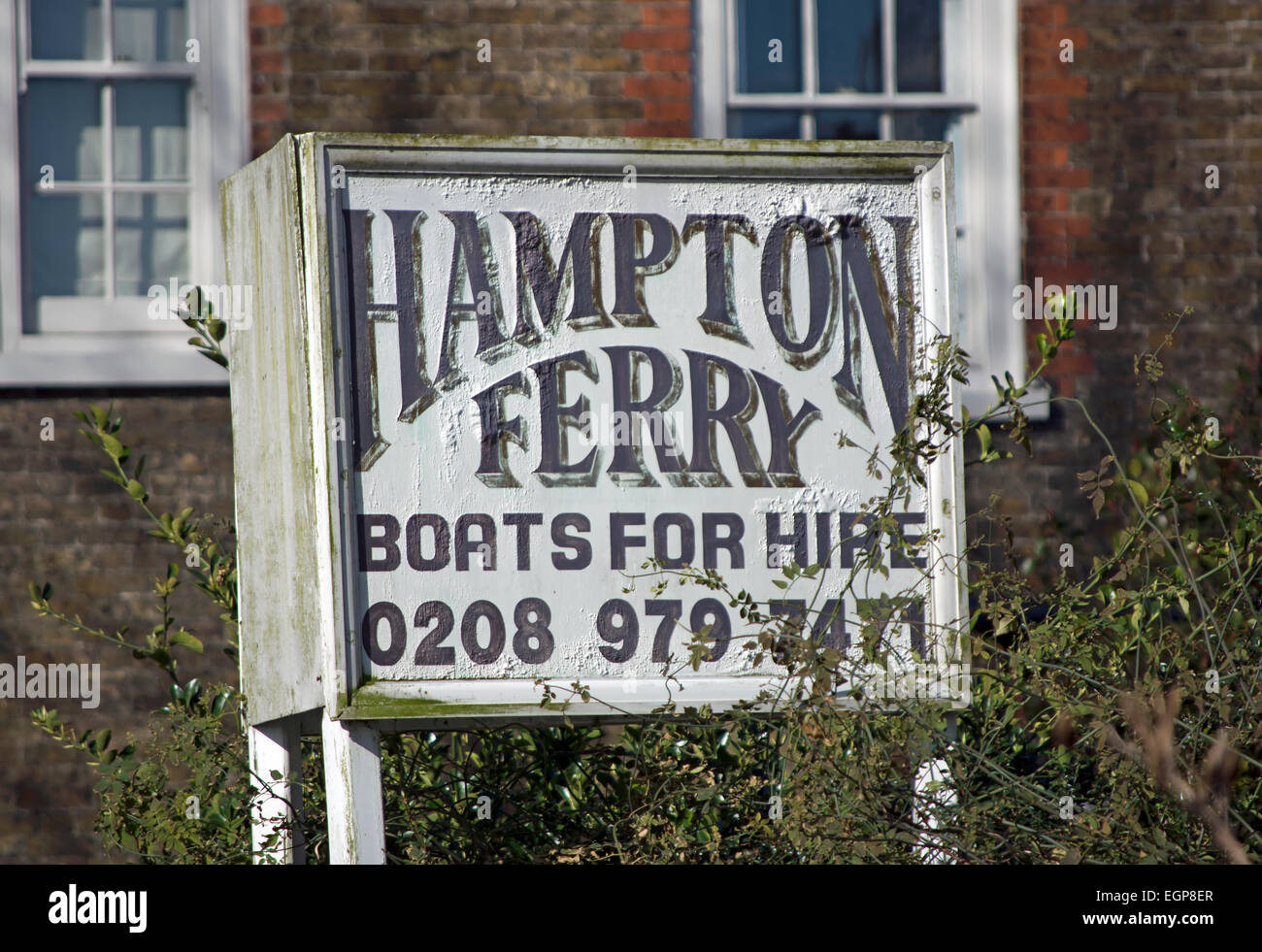sign for the hampton ferry, and boats for hire, on the river thames in hampton, middlesex