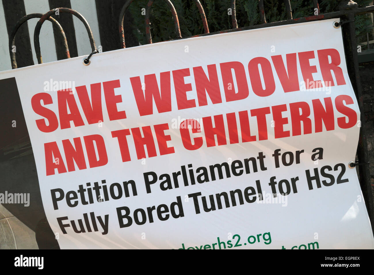 A 'Save Wendover & the Chilterns' (anti-HS2) poster on a railing in the shopping high street of Wendover, Buckinghamshire, UK. Stock Photo