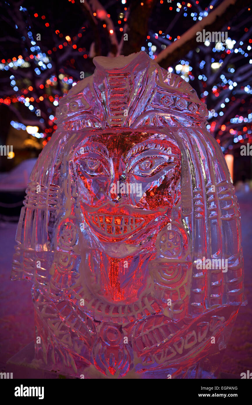 Egyptian queen ice sculpture with red purple lights at Yorkville Village Park Icefest Toronto Cumberland street at night Stock Photo