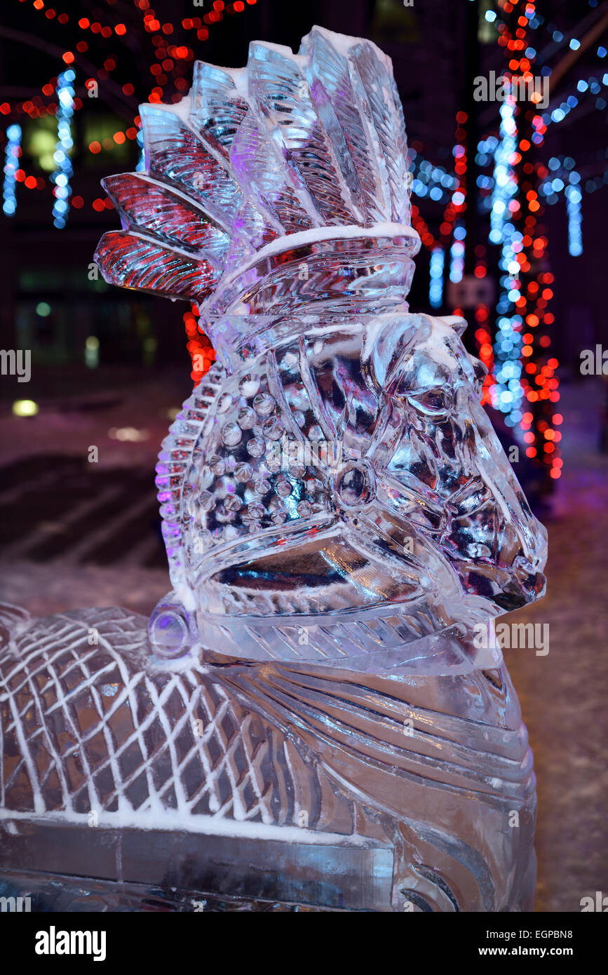 Plumed horse ice sculpture with Chrismas lights at Yorkville Village Park Annual Icefest Toronto Cumberland street at night Stock Photo