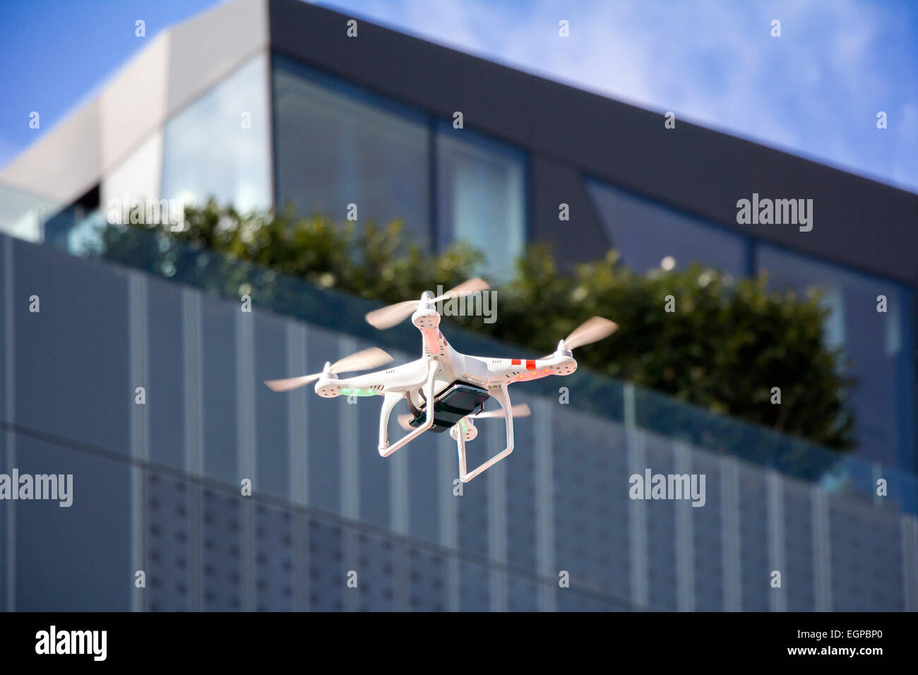 Radio controlled quadcopter drone flying in the city Stock Photo