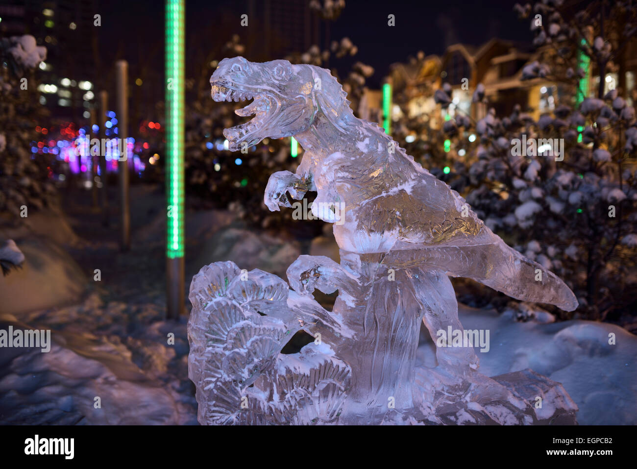 Tyrannosaurus dinosaur ice sculpture Yorkville Park Icefest Toronto at night in winter Stock Photo