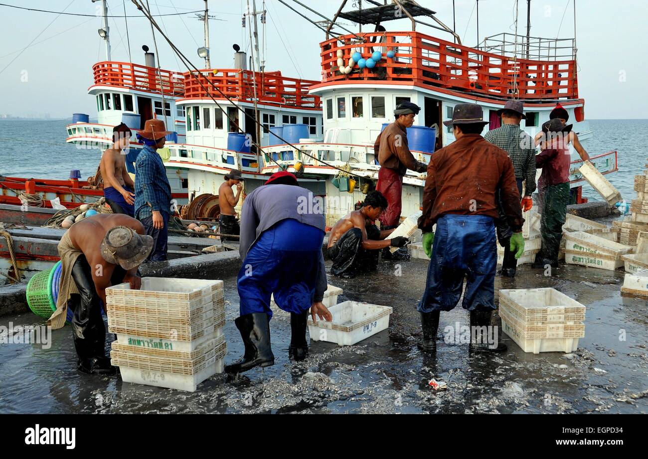 Hua Hin, Thailand: Thai fishermen cleaning, washing, and stacking plastic storage  boxes at the Hua Hin public pier Stock Photo - Alamy