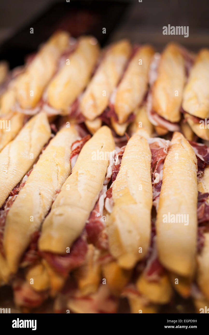 lot of iberian ham panini french bread sandwiches stacked ready to eat Stock Photo