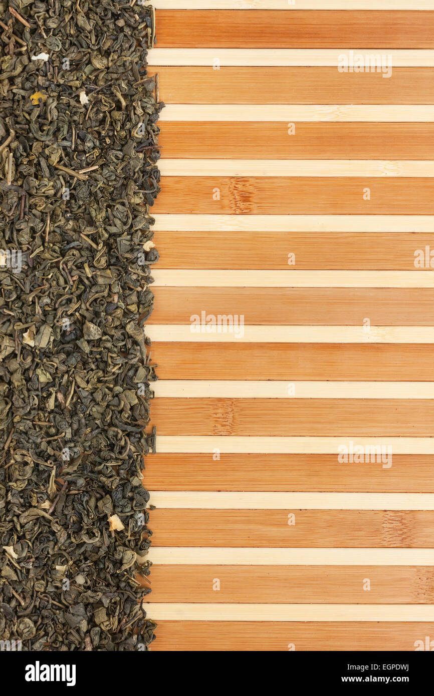 Dried  green  tea  on a bamboo mat, with space for text, for menu Stock Photo
