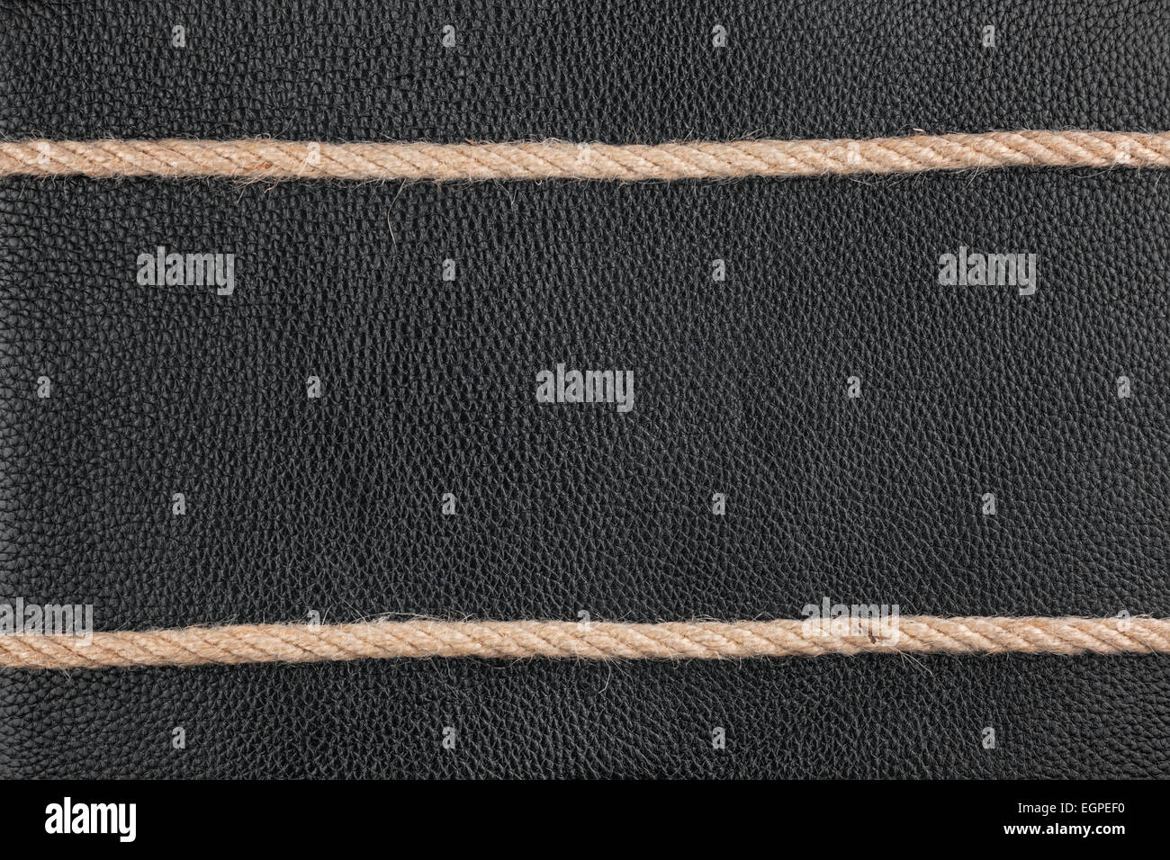 The two ropes lie on natural leather, with space for text Stock Photo