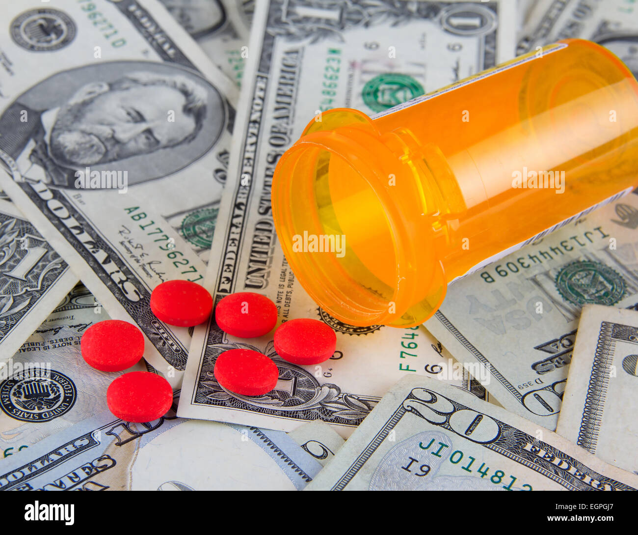 Rising health care expenses in America - pills on US dollar bills Stock Photo