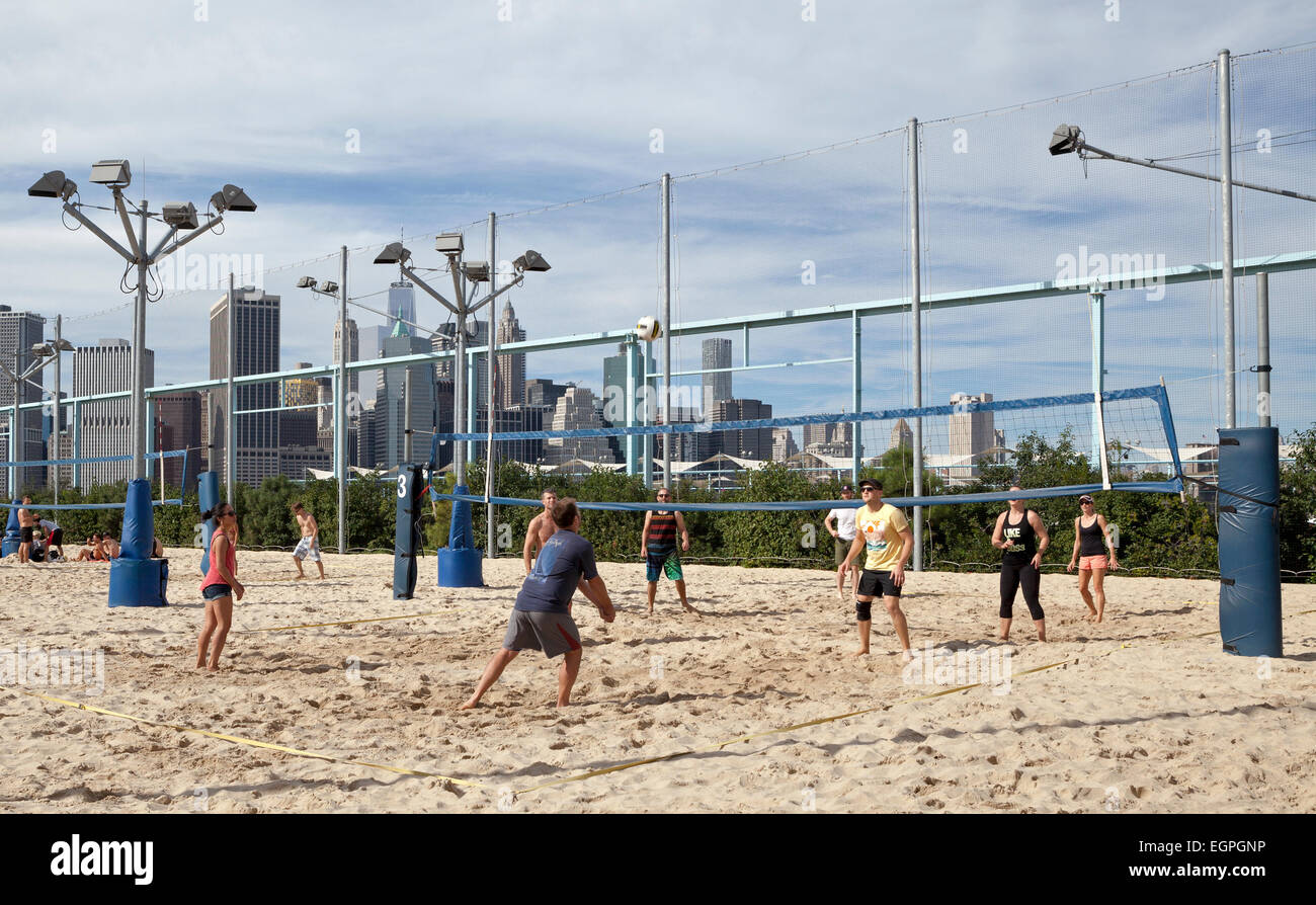 People play a game of sand volleyball in Brooklyn, New York City Stock