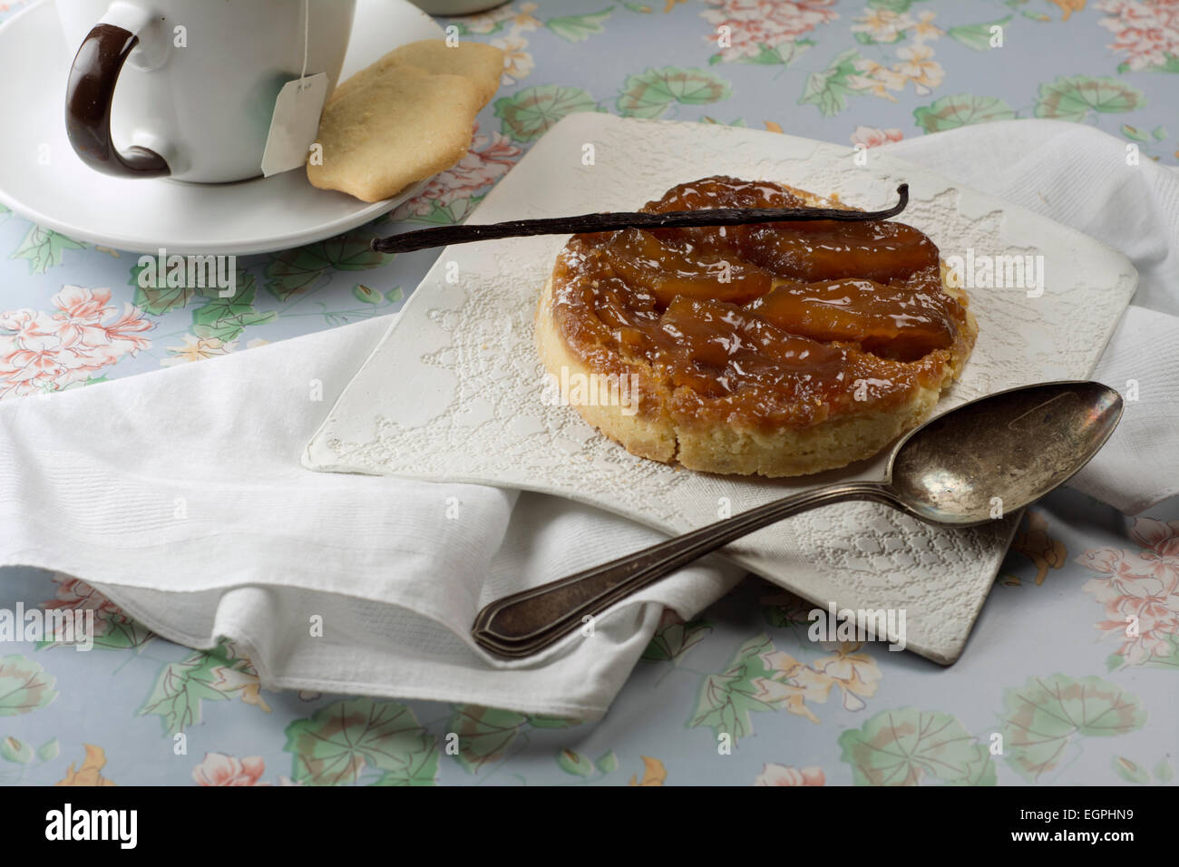 tarte tatin, at breakfast table, next to the cup of infusion Stock Photo