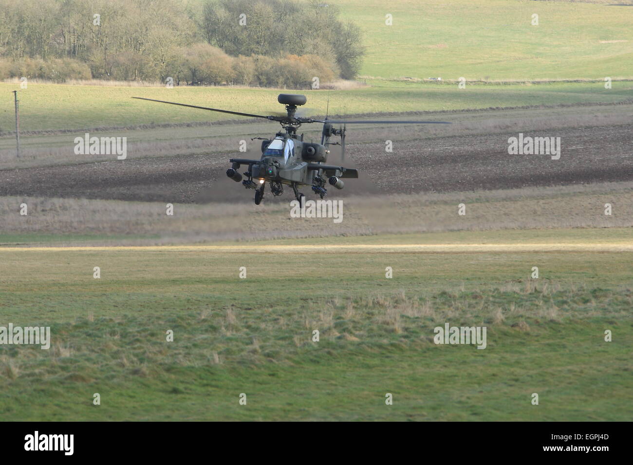 British Army Apache AH1 Attack helicopter flies at low level on a training exercise. Stock Photo
