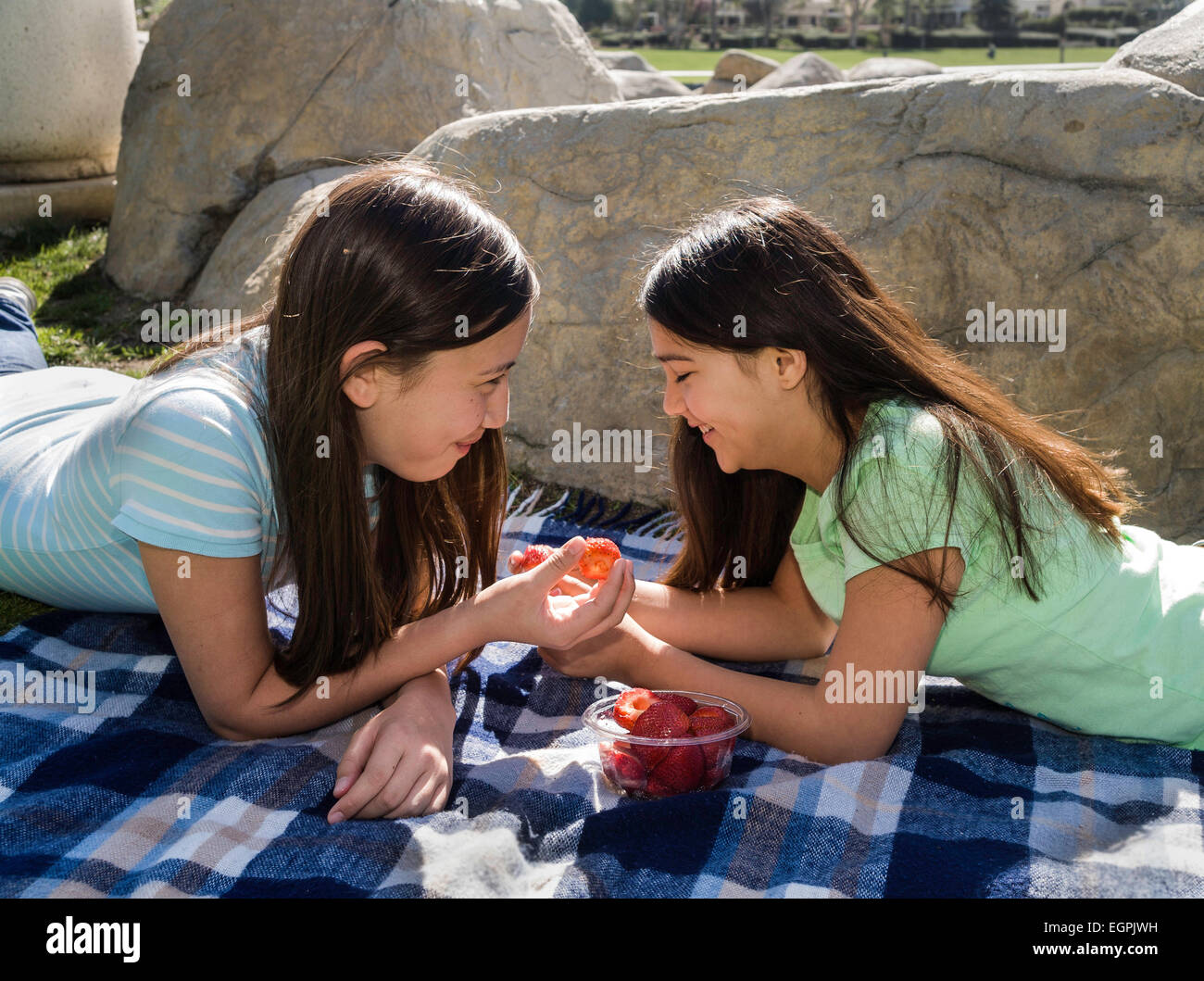 Tweens California Teens hanging out tweens Tween girls talking.  Vietnamese/Caucasian and Hispanic/Caucasian girls share fruit friendship .  MR © Myrleen Pearson Stock Photo - Alamy