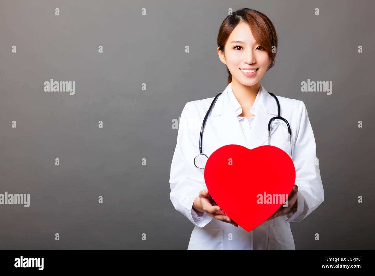smiling asian female doctor with heart Stock Photo