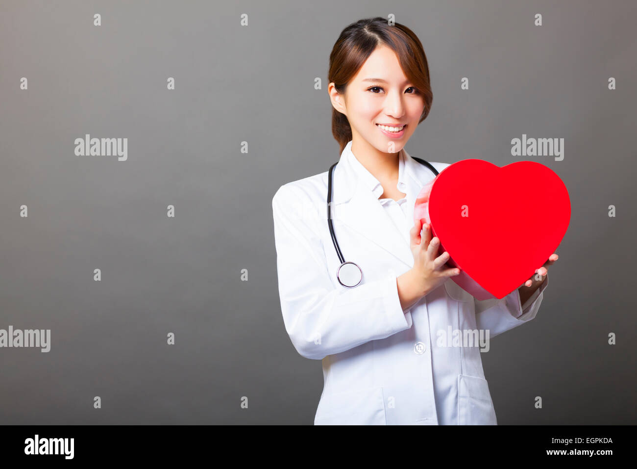 smiling asian female doctor with heart Stock Photo
