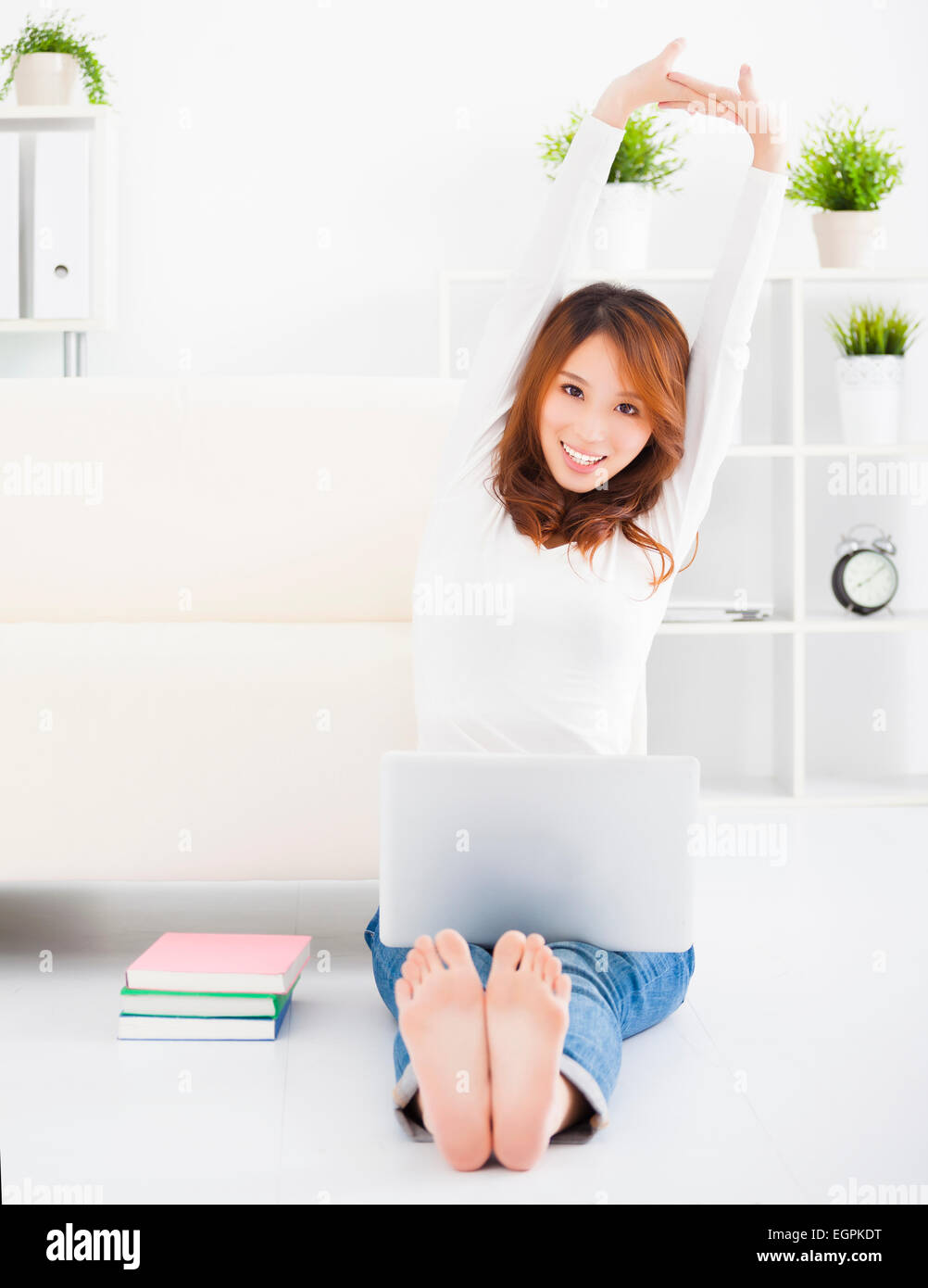 smiling Young woman sitting on the floor with laptop Stock Photo - Alamy