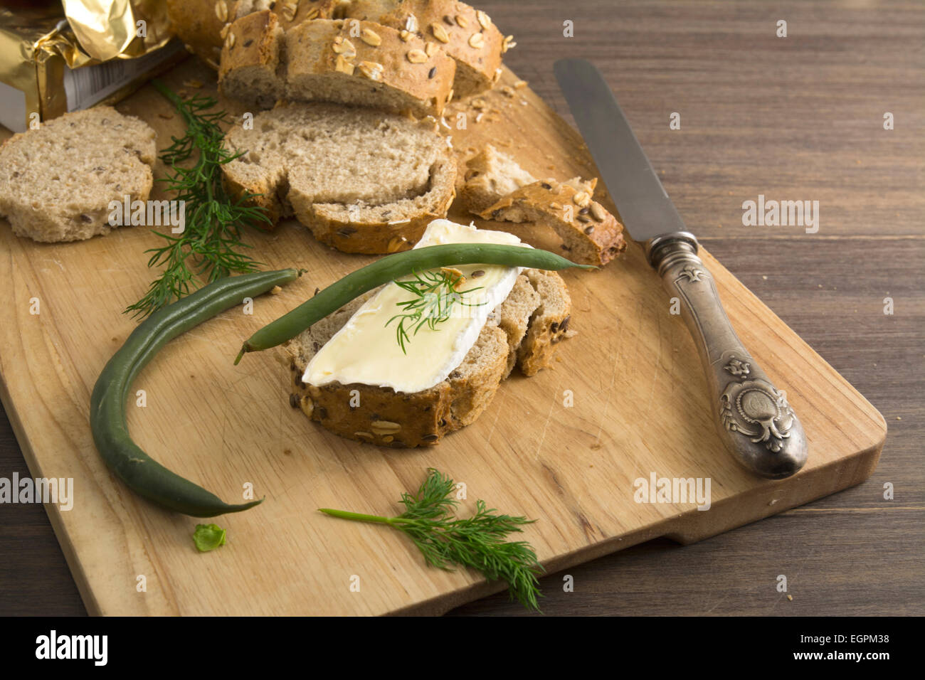 bread served with chesse brie, on wooden board Stock Photo