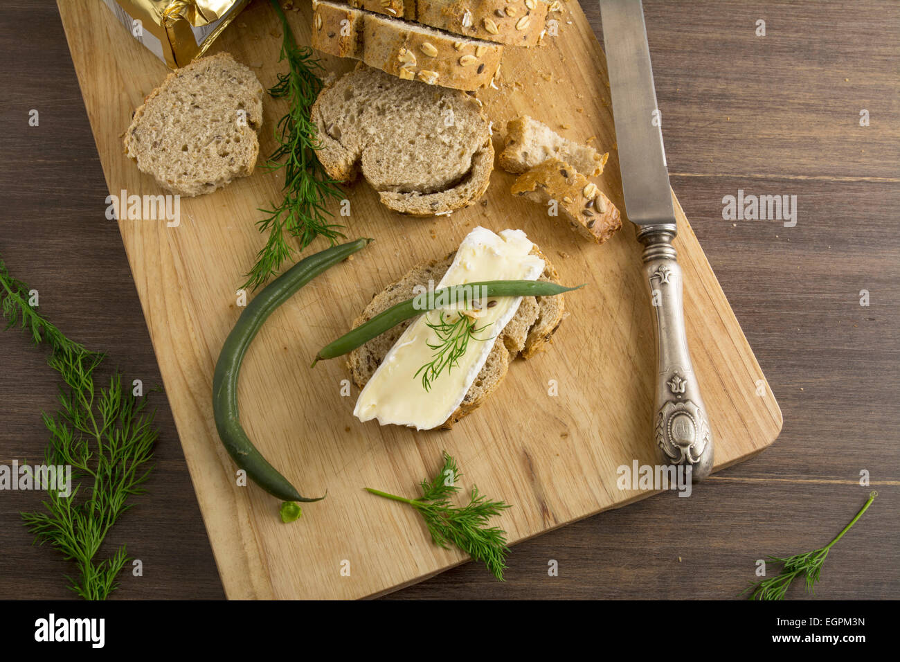 bread served with chesse brie, on wooden board Stock Photo