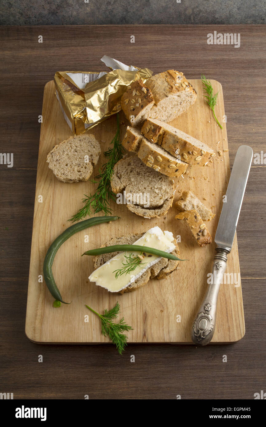 bread served with chesse brie, on wooden board Stock Photo