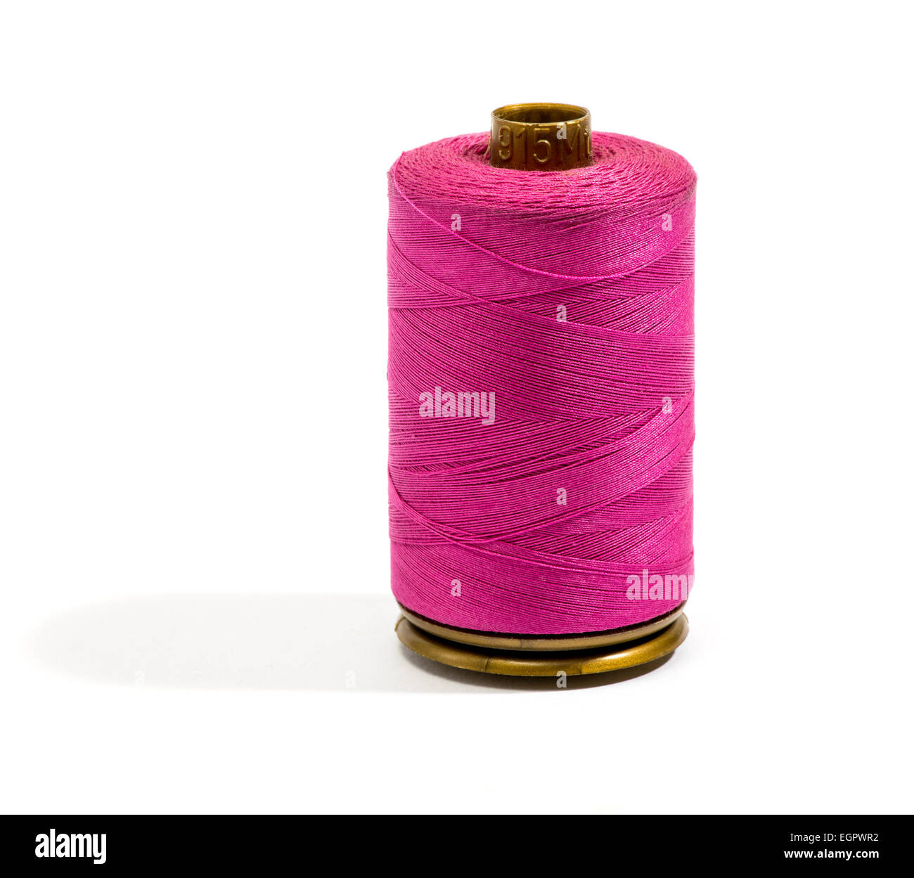 Close up Dark Pink Cotton Thread on a Standing Reel Stock Photo