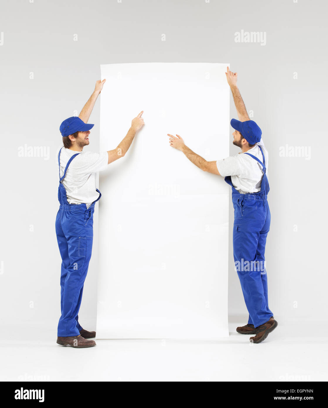 Two young builders planning the renovation Stock Photo