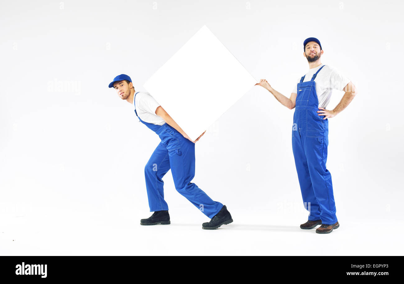 Two young builders holding a white board Stock Photo