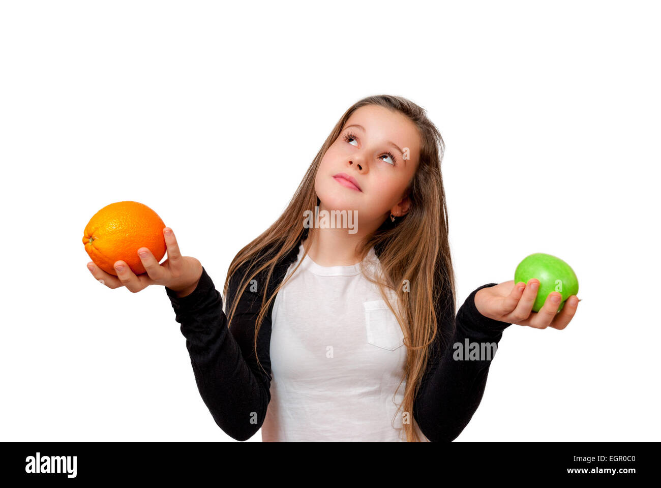 Thinking little girl with orange  isolated on white Stock Photo