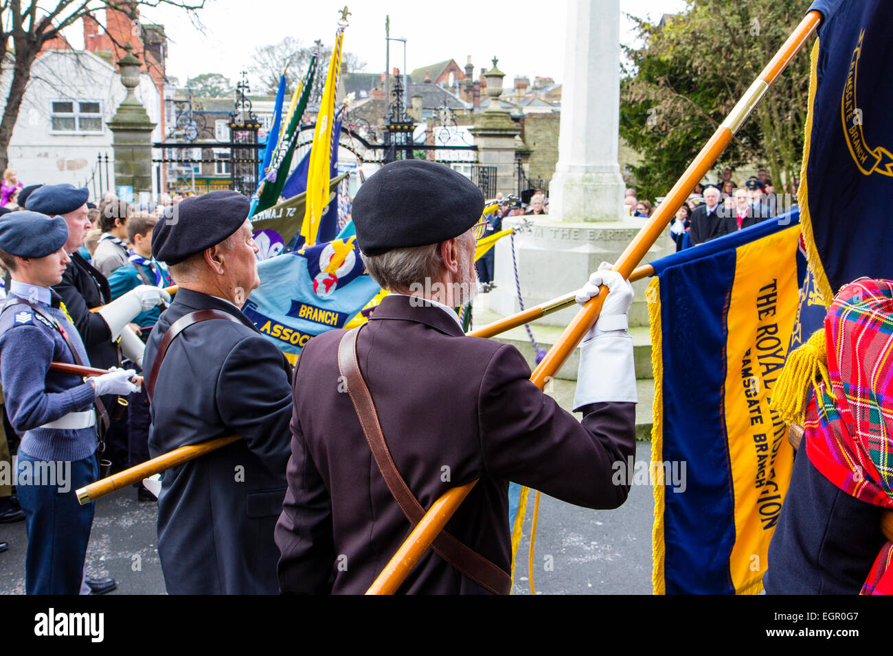 Ramsgate, remembrance sunday. Row of senior ex-servicemen standing to attention while lowering banners and flags for the minutes silence at 11 o'clock. Stock Photo