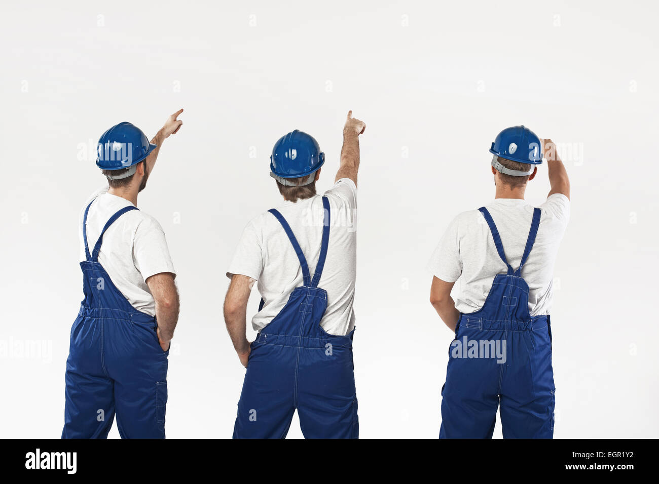 Three young builders making a renovation Stock Photo