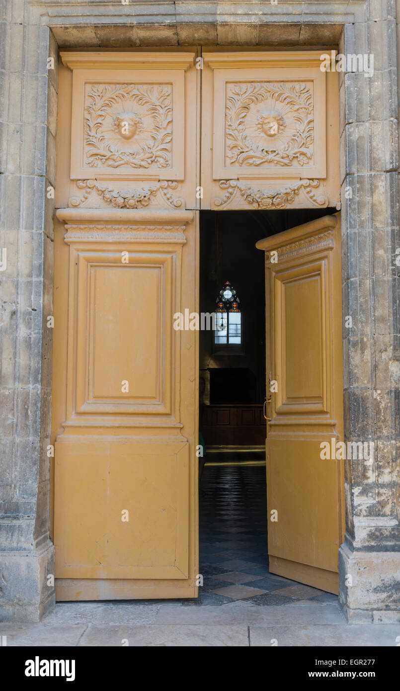 Old wooden church door that is open in Orleans in France. Stock Photo