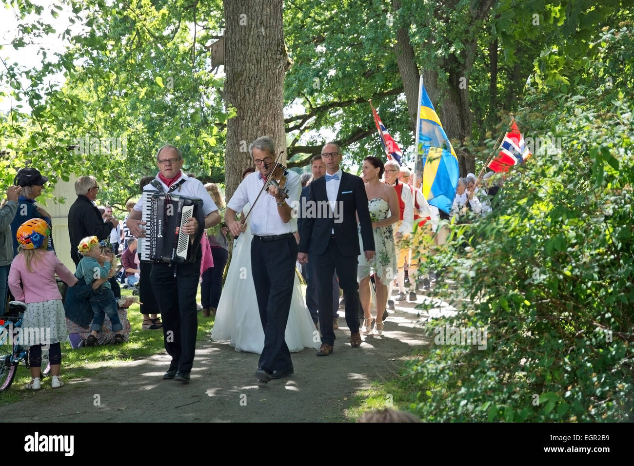 ALSTER, KARLSTAD, SWEDEN - JUNE 20, 2014: People at Midsummer celebrations and Norwegian - Swedish wedding on June 20, 2014 in A Stock Photo
