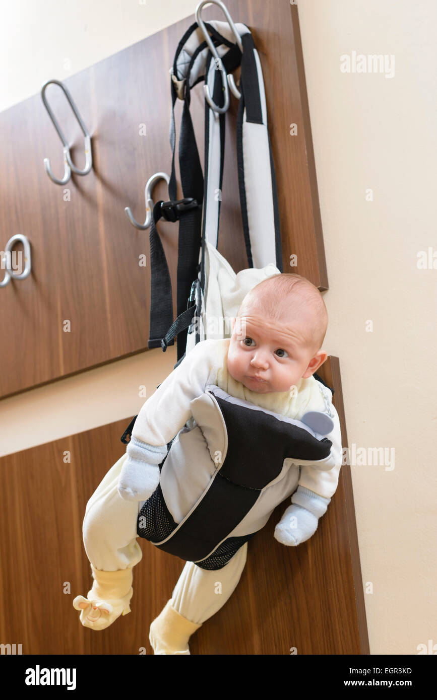 Cute baby sitting in a front baby carrier Stock Photo