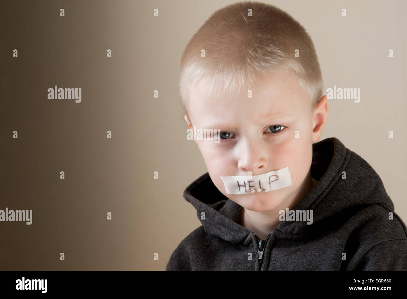 Upset abused frightened little child (boy), help, close up horizontal portrait with copy space Stock Photo