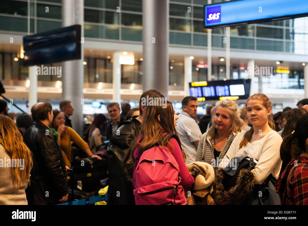 Copenhagen, Denmark, March 1, 2015: Stranded passengers in Copenhagen Airport.  SAS cabin crew wildcat strike in protest of being transferred to another  SAS subsidiary with weak union agreement causes grounded flights to and from Copenhagen and leaves passengers in uncertainty. Waiting lines are growing as crew has not returned back to work Credit:  OJPHOTOS/Alamy Live News Stock Photo