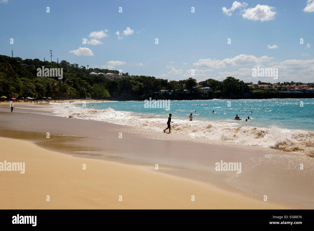 Tourists and locals swimming in the Atlantic ocean in the holiday resort of Sosua, Puerto Plata, Dominican Republic, Caribbean Stock Photo