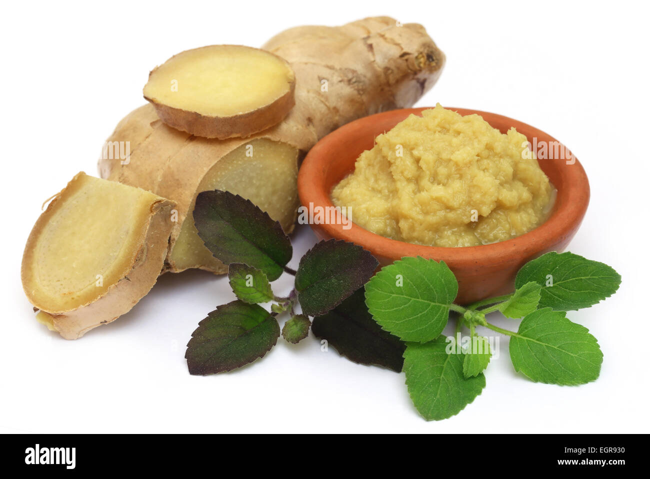 Fresh crushed ginger with holy basil over white background Stock Photo
