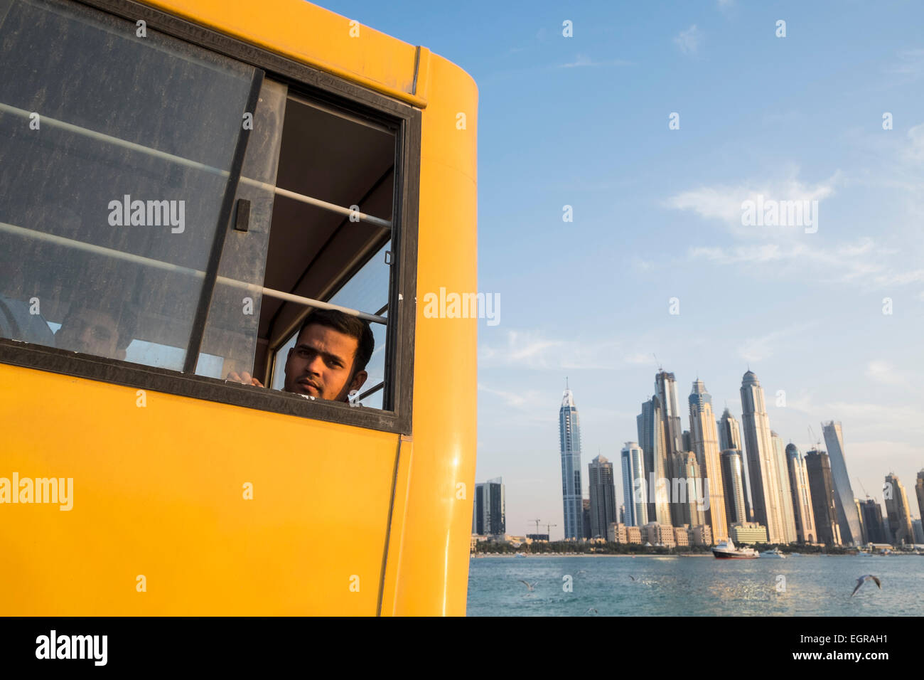 Construction worker on bus to living quarters at end of working day in Dubai United Arab Emirates Stock Photo
