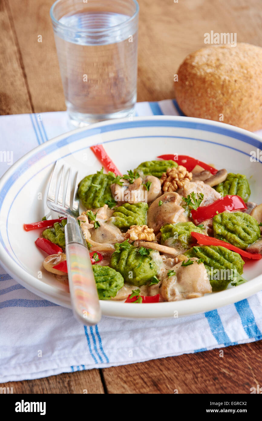Spinach gnocchi with mushrooms and bell pepper Stock Photo Alamy