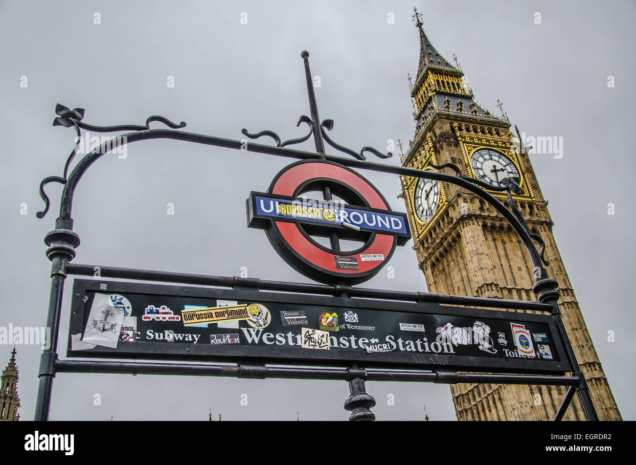Stickers applied to Westminster Underground station signage by visiting Borussia Dortmund football fans during their visit to London. Big Ben. UK Stock Photo