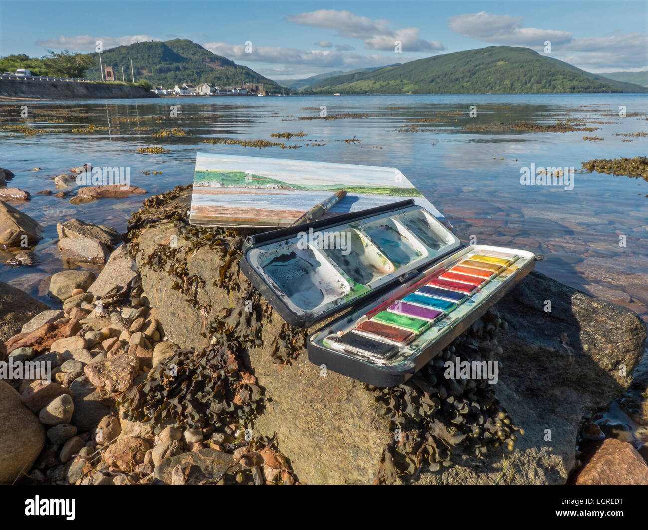 Painting Box, sketch pad and brush on the side of Loch Fyne, Scotland, UK. Stock Photo