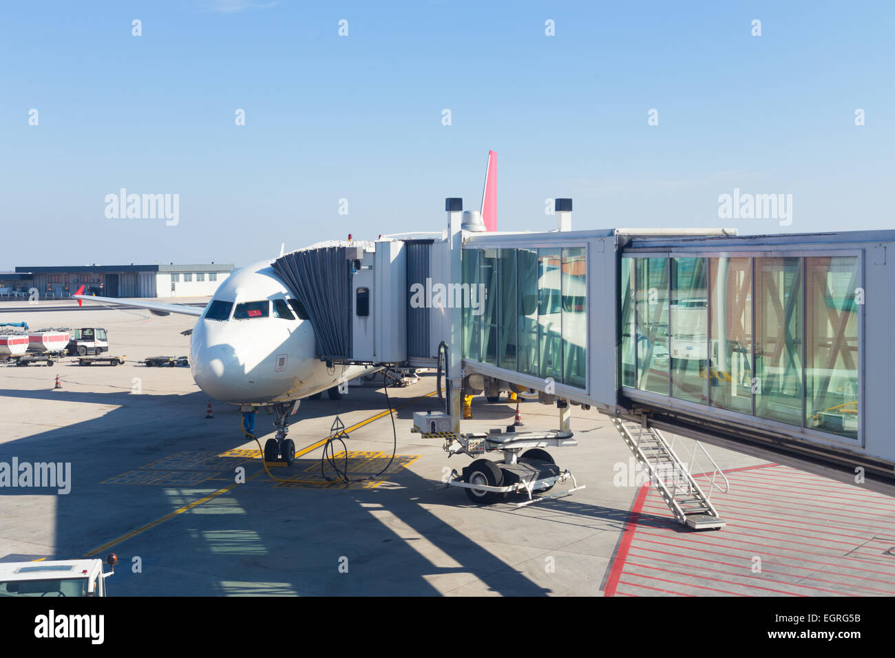Jetway conecting plane to airport departure gates. Stock Photo