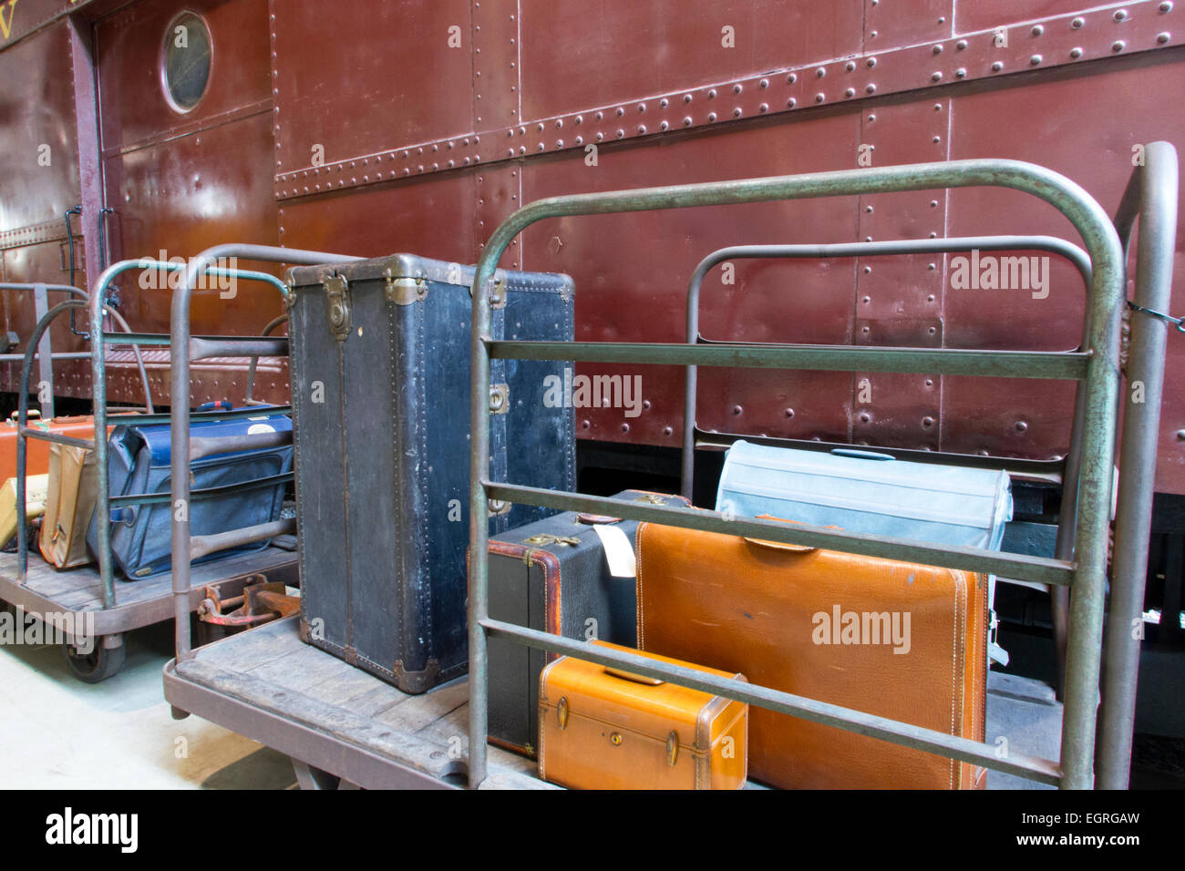 Luggage on cart next to vintage train baggage car Stock Photo Alamy